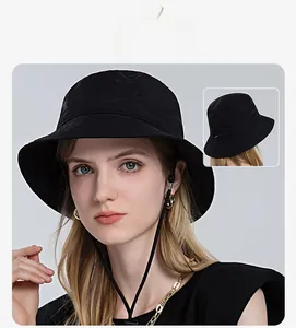 Detail of black summer sun hat with adjustable chin strap and wide brim for sun protection