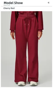 Detail of cherry red high-waisted sweatpants featuring adjustable drawstring waist
