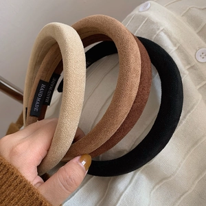 Three thin suede padded headbands in beige, brown and black colors with handmade tag