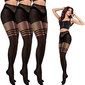 Detail of black patchwork fishnet tights featuring wide striped mesh and sheer leg panels