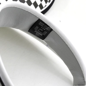 Detail view of the breathable mesh lining and size label on a sun visor hat