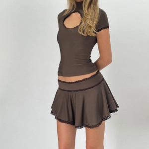 Detail of brown lace-up short sleeve top and matching mini skirt set with hollow-out design