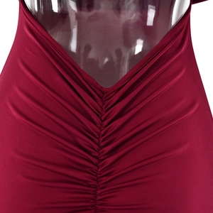 Close-up of the wine red backless dress featuring elegant ruching and V-shaped cut detail