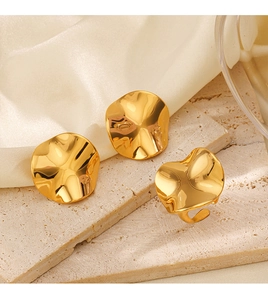 Detailed view of 18K gold plated irregular round earrings and ring set on satin