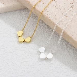925 sterling silver heart bracelet set in gold and silver finish on stone background