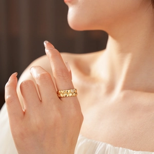 Detailed macro of 18k gold plated open ring with double row heart shapes and pavé diamonds