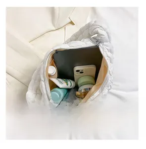 Internal view of a large white quilted cloud bag showing spacious storage for iPad and daily items