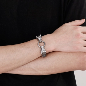 Detailed view of punk wolf head steel bracelet worn on wrist with vintage silver finish