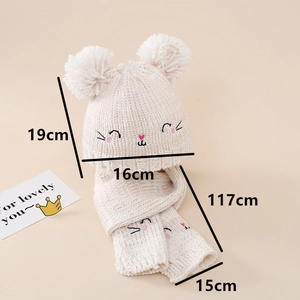 Detailed knit texture of baby hat and scarf set with cute cat embroidery and pom-poms