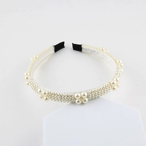 Elegant pearl woven headband for women with off-white faux pearls on white stand