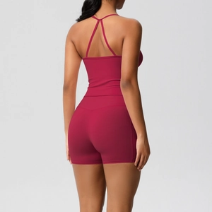 Detail of the cross-back straps on this rose red yoga tank top and high waist shorts set