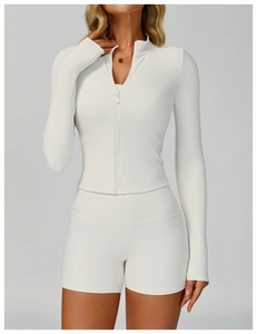 Close-up of white ribbed fabric texture and metal zipper detail on slim fitness jacket