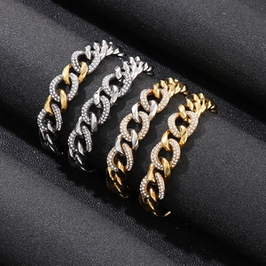 Detailed view of cuban chain rings in gold and silver finish with pavé set zirconia crystals