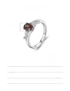 Macro shot of S925 silver ring featuring an oval red gemstone and pavé diamonds detail