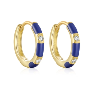 Macro shot of gold hoop earrings with blue enamel finish and sparkling crystal accents