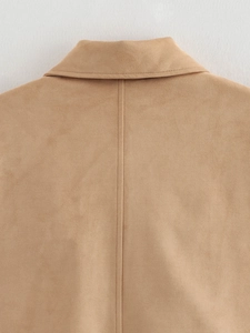 Detailed macro view of camel suede jacket showing back seam and premium fabric texture