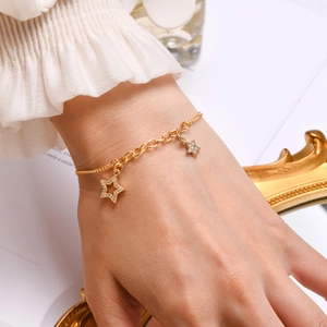Detailed view of 18K gold plated bracelet featuring elegant zircon star pendants on wrist