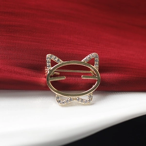 Detailed macro view of the gold-plated cat outline brooch with sparkling zircons