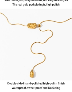 Detailed shot of PVD gold plated irregular lava pendants on a sleek snake chain necklace