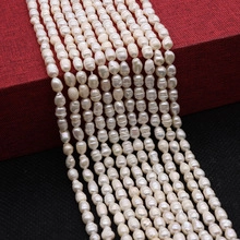 Macro view of white rice-shaped freshwater pearls with natural luster for DIY jewelry