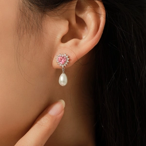 Elegant S925 silver heart earrings with pink stone and teardrop pearl on model