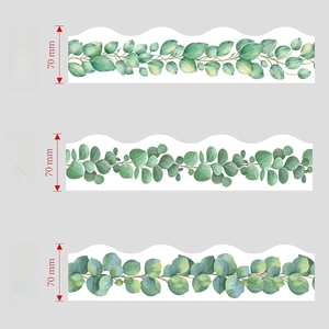 Detailed close-up of three hand-painted green leaf bulletin board border stickers with wavy edges