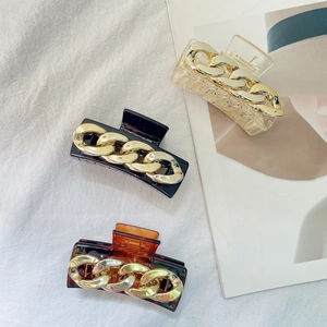 Retro geometric hair claws with gold chain detail in clear black and tortoiseshell