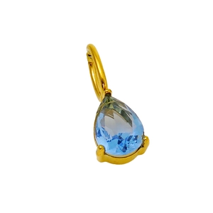 Macro view of a light blue pear-cut gemstone pendant with a golden three-prong setting