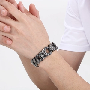 Detailed close-up of retro engraved patterns on a heavy stainless steel men's chain bracelet