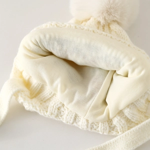 Winter knit hat for children featuring a soft beige lining and thick white outer wool