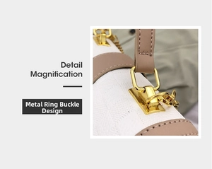 Detailed macro view of the golden metal hardware clasp on white textured handbag
