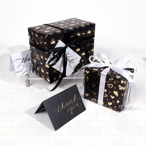 Black and gold heart wrapping paper set with elegant ribbons and thank you cards