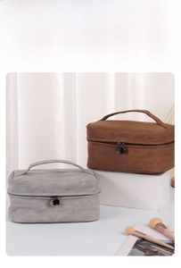 Detail of grey and brown PU leather cosmetic bags with matte finish and dual zippers