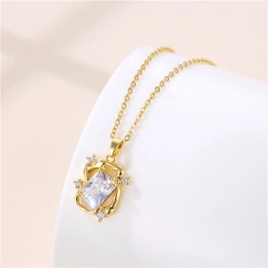 Macro detail of rectangle crystal pendant on a thin gold chain with diamond accents