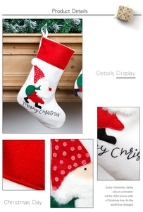 Detailed view of white Nordic Christmas stocking with Santa embroidery and knit textures