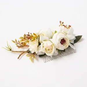 Macro detail of bohemian floral hair comb with silk roses and silver metallic tines