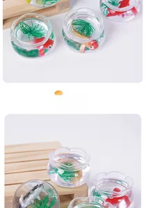 Close-up of miniature resin fish tank with colorful koi and green aquatic plants
