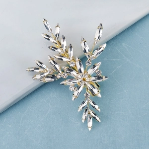 Detailed macro of crystal leaf hair clip with marquise rhinestones on gold base
