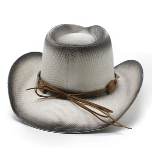 Detail of western straw cowboy hat featuring gradient paint and faux leather band accent