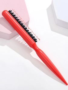 Detail of red hair styling brush with boar bristles and pointed tail handle
