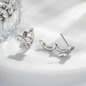 Elegant silver bow earrings with zircon stones and minimalist ear buckle design