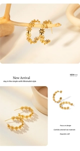 Detailed macro shot of vintage gold flower C-shaped earrings with 18k gold plating