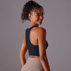 Macro shot of black racerback sports bra with seamless moisture-wicking fabric and ergonomic fit