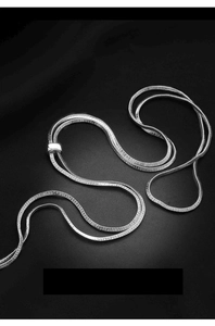 Detail of silver double-layered snake chain with polished square slider on black background