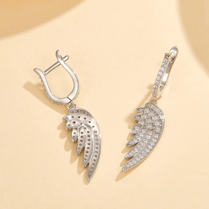 Detailed macro shot of S925 sterling silver feather earrings with zircon inlay