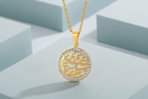 Close-up of gold hollow tree pendant with sparkling rhinestones on geometric cubes