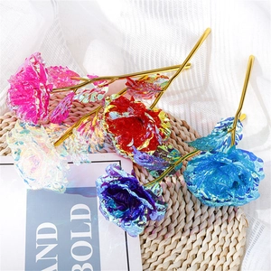 Colorful gold foil roses in pink, blue and purple on a rustic woven mat background