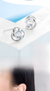 Macro shot of S999 silver spiral earrings with round brilliant cubic zirconia stones