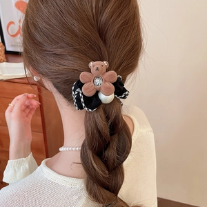 Detail of bear charm hair tie with crystal, pearl and gingham fabric on low ponytail