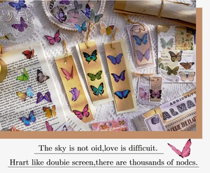 Detail of vintage butterfly stickers and bookmarks on old books and lace background